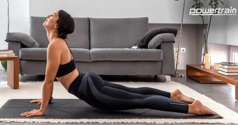 Cobra pose to relieve back pain Woman stretching out in cobra pose