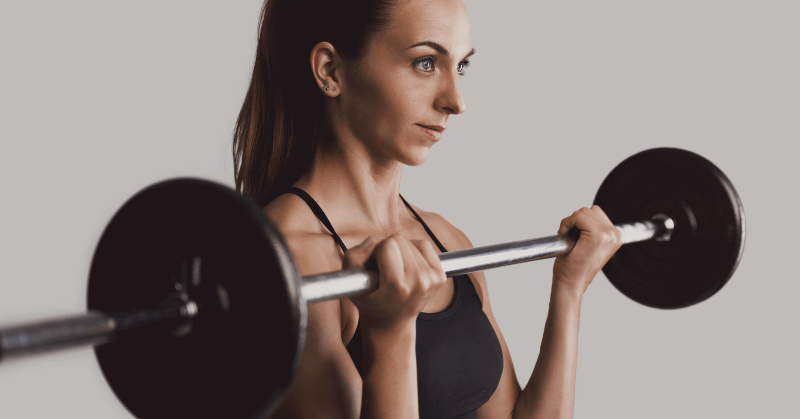 A female runner lifting a barbell