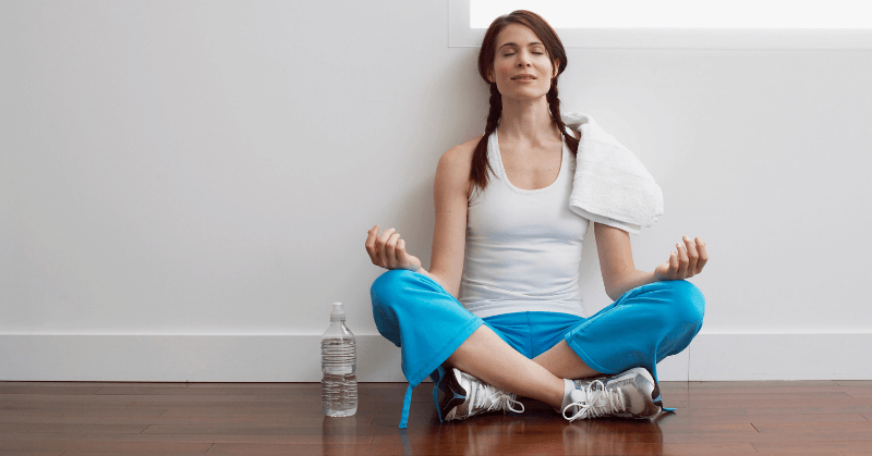 A woman meditating at home