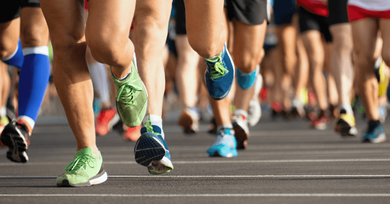 Various pairs of running shoes during a race