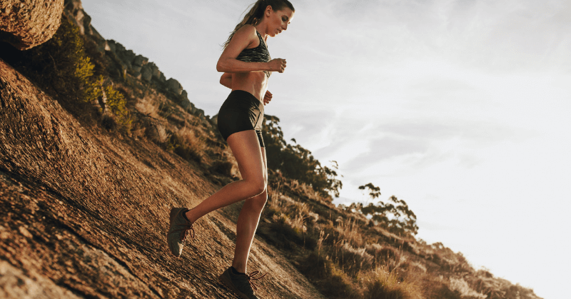A woman running on a hill A woman running on a hill