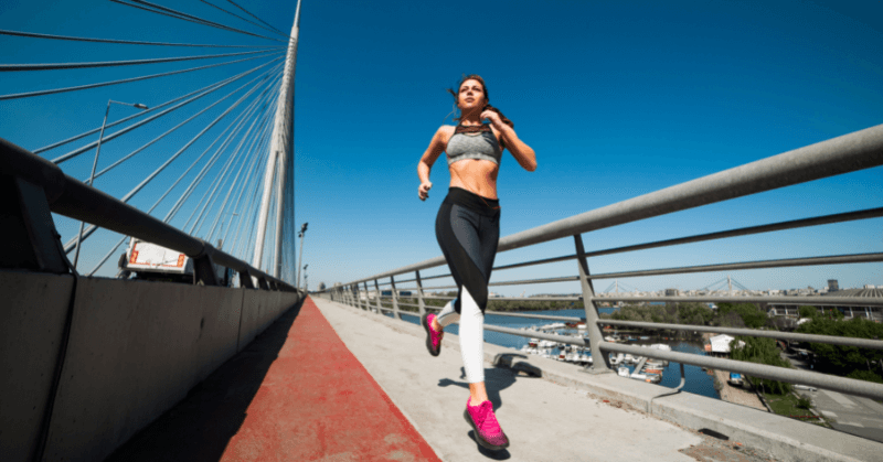 Woman running on a bridge